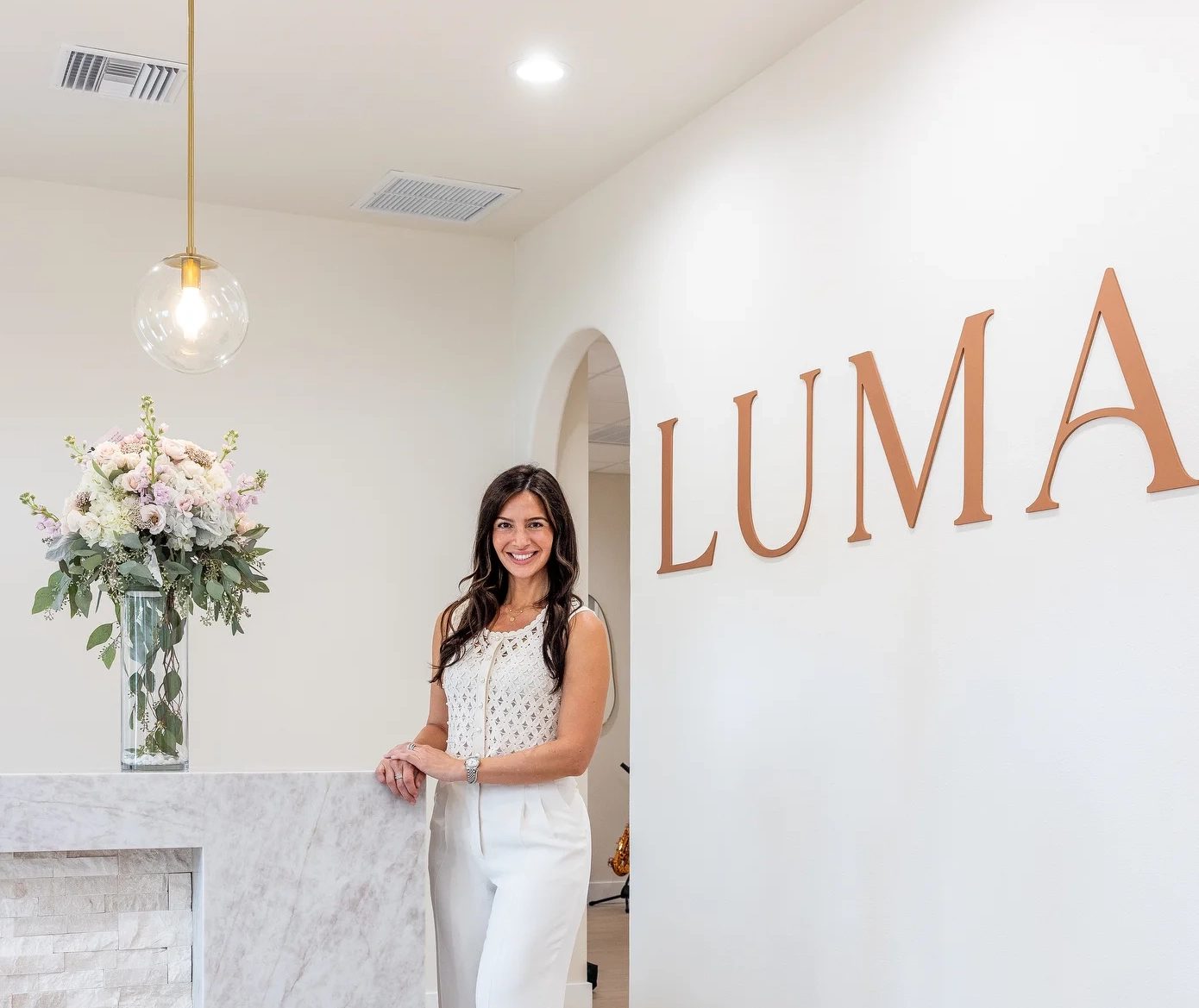 Dr. Sylvia Zannis at the front desk of the Luma Biological Dentistry office in Sarasota