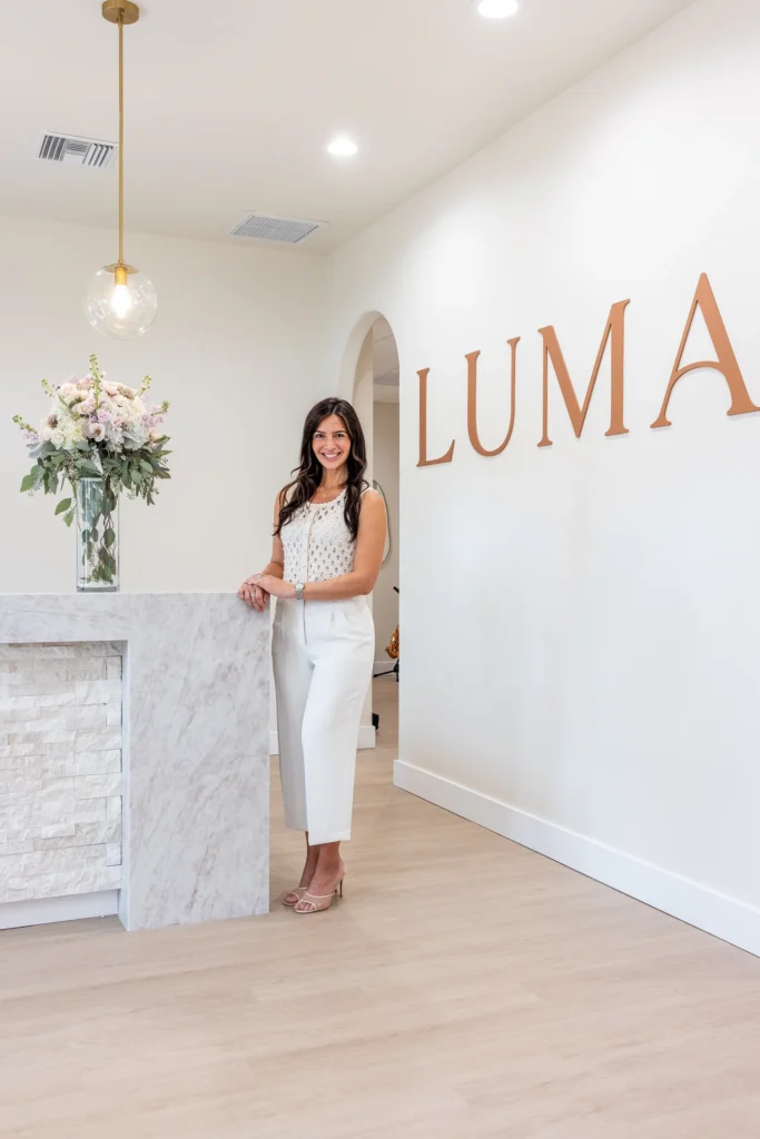 Dr. Sylvia Zannis at the front desk of the Luma Biological Dentistry office in Sarasota