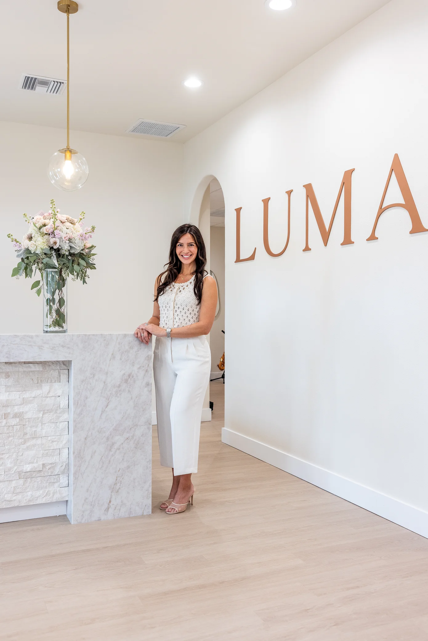 Dr. Sylvia Zannis at the front desk of the Luma Biological Dentistry office in Sarasota